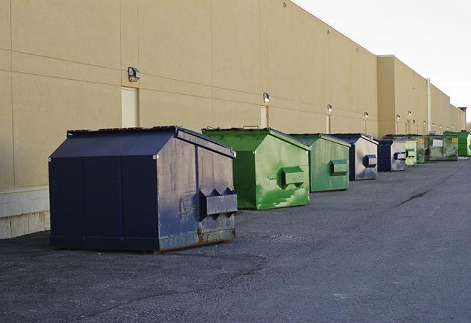 a row of large construction dumpsters on-site in Chase